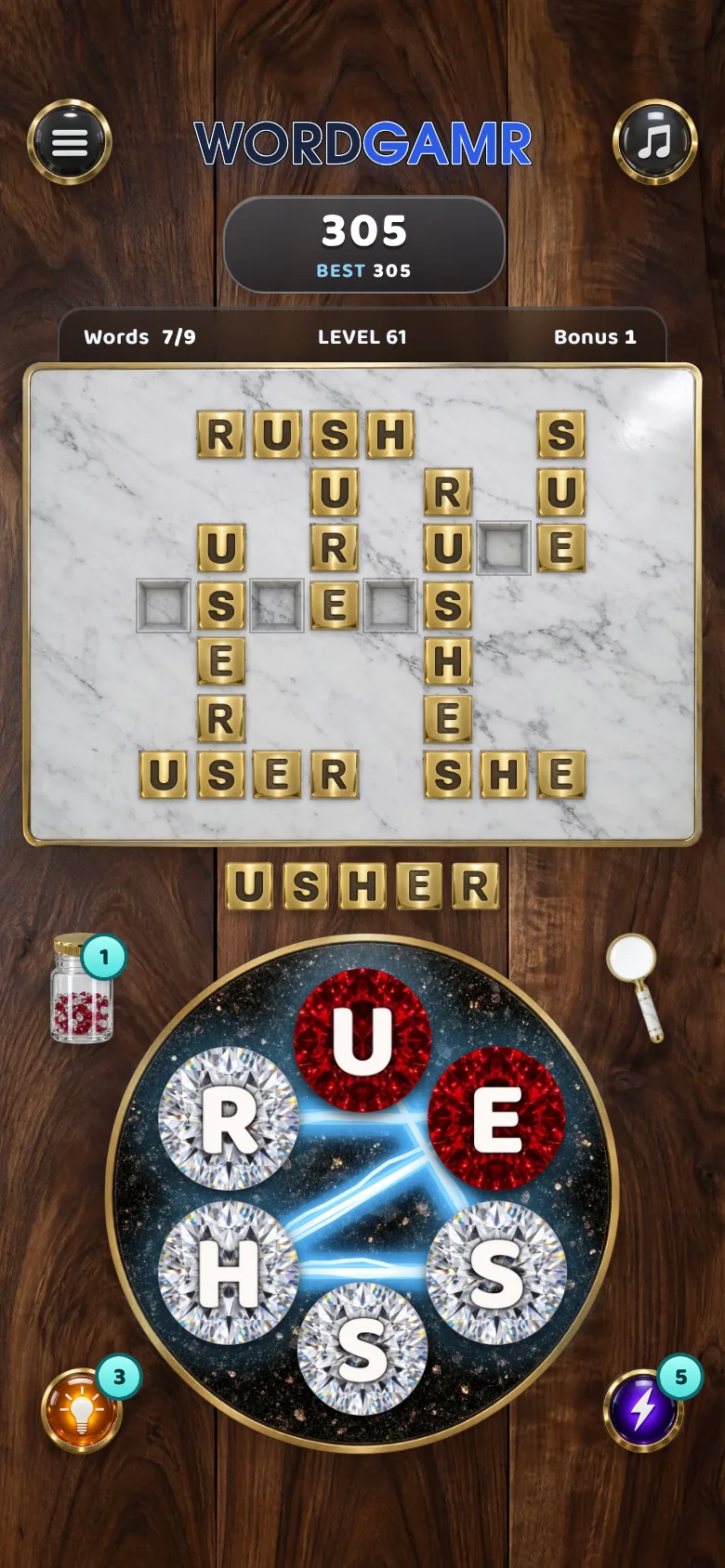 The same round in Marble & Brass: brass tiles on marble, ruby and crystal letters, walnut behind